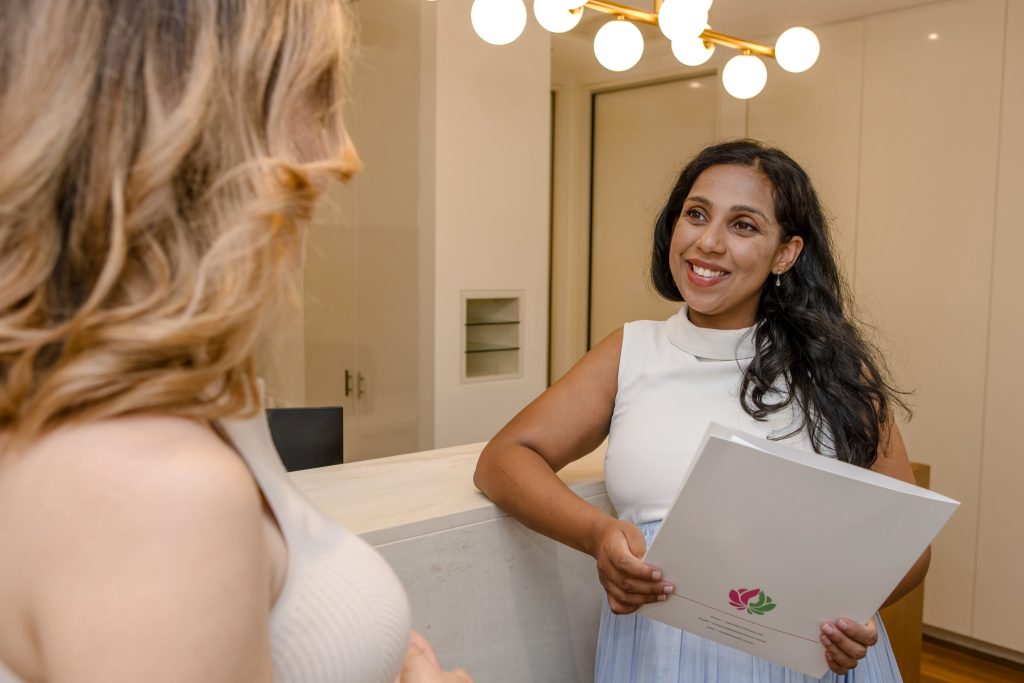 doctor talking with a young female patient